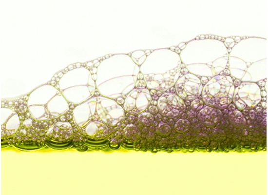 Foam bubbles forming above lubricating oil